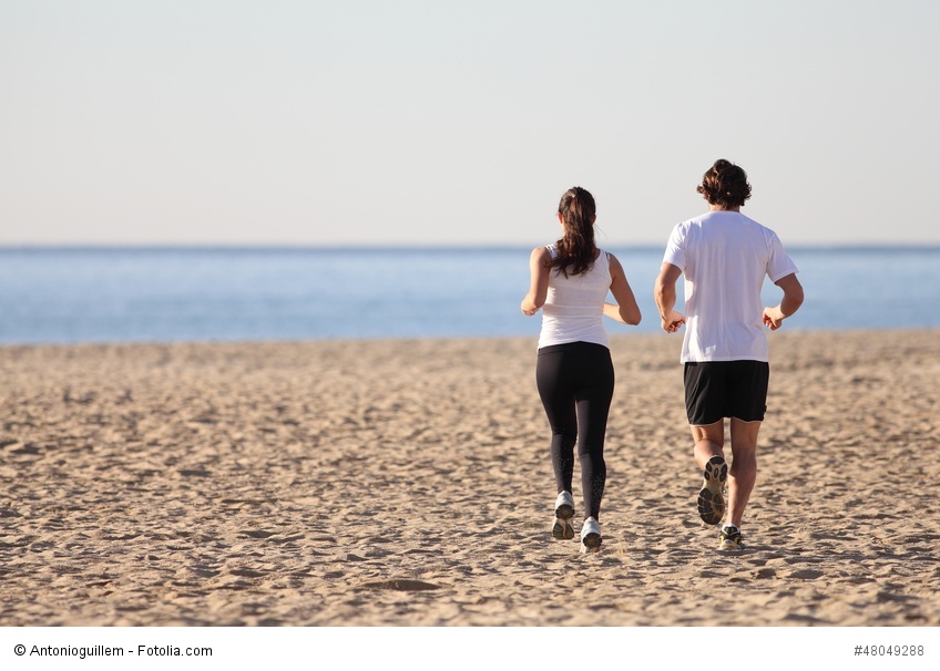 Man and woman running in the beach